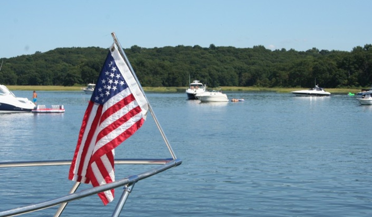 American flag on front of boat overlooking bay area