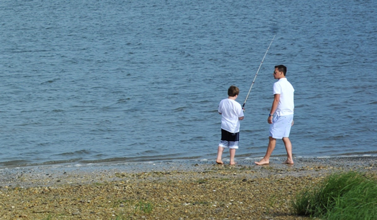 Father and son fishing at the beach