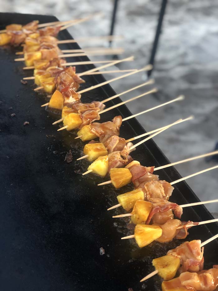 chicken skewers being grilled