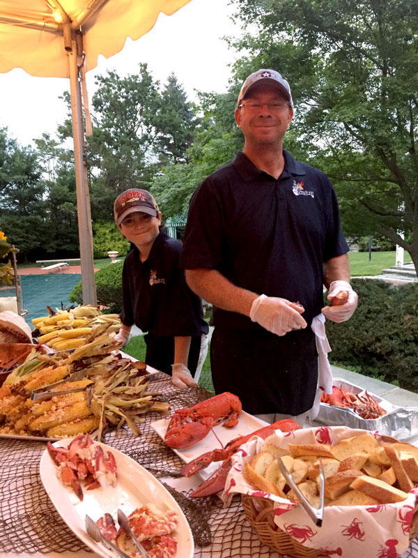 jimmy-schultz-with-his-kid-preparing-food-during-clambake